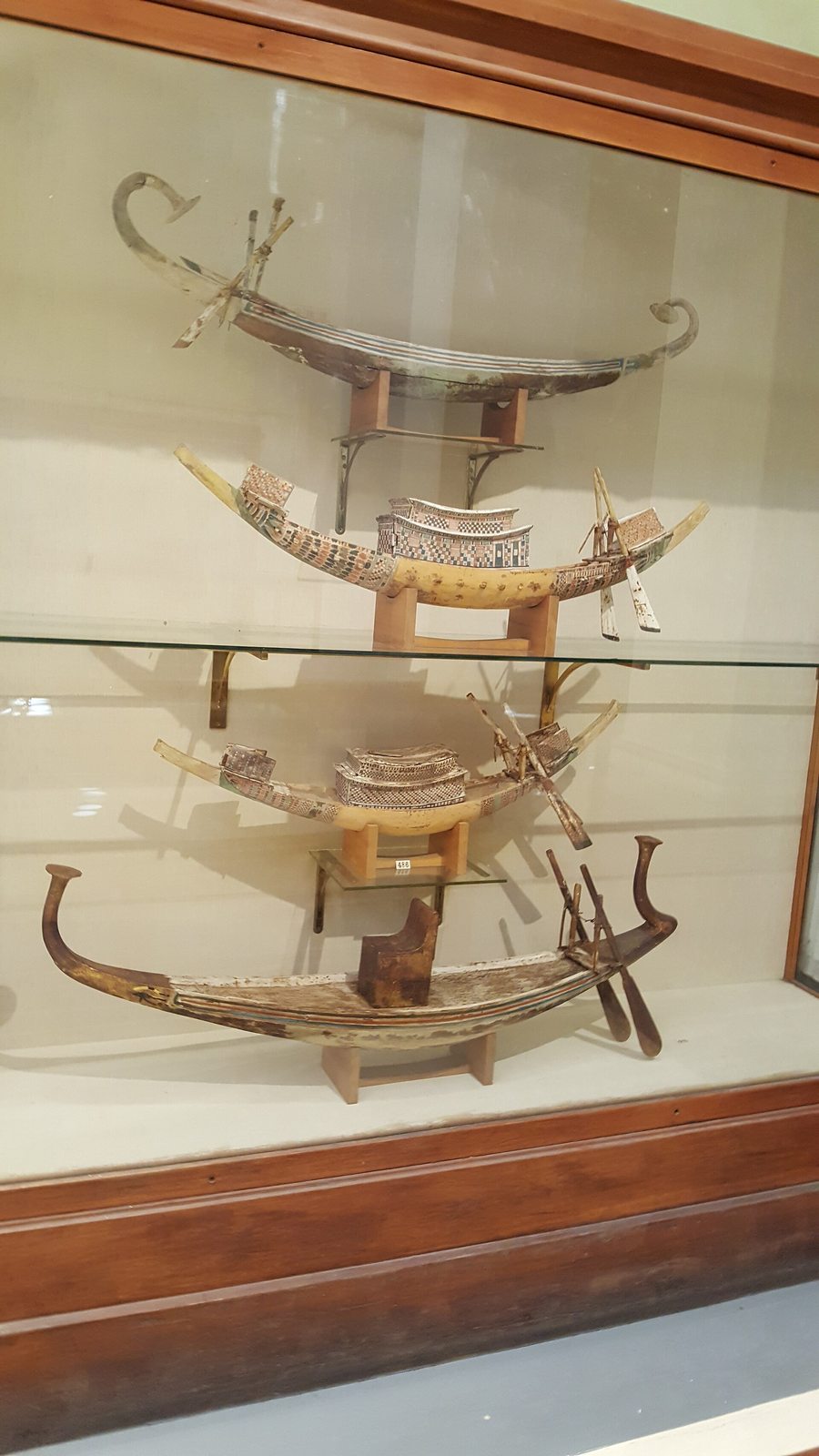 Tall display case photographed within a museum gallery